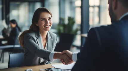 Fotobehang job interview,Handshake,finishing successful meeting,Business etiquette,congratulation,meeting,new business,startup,employee,teamwork,trust concept.Young business people shaking hands in the office. © Amonthep