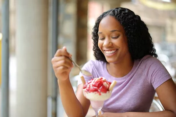 Fotobehang Happy black woman eating ice cream © PheelingsMedia