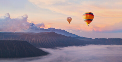 beautiful inspirational sunrise landscape with hot air balloons in sky, nature travel destination,...