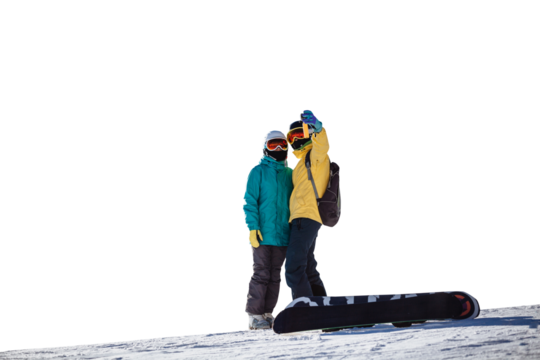 Skiers taking picture of themselves with smartphone