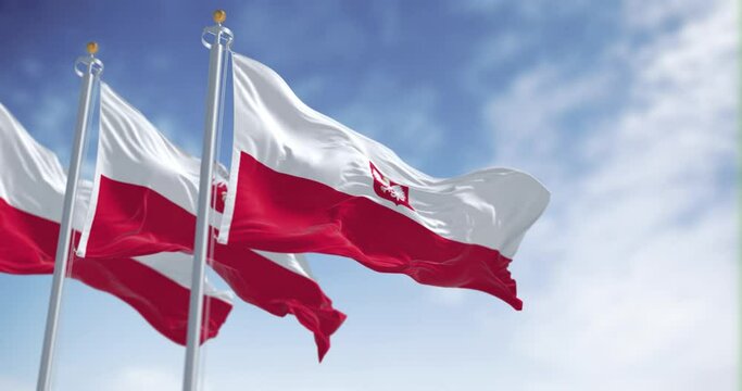 Three national flags of Poland waving in the wind on a clear day