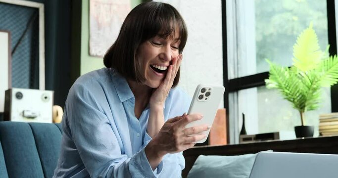 A Caucasian woman is delighted as she receives positive news on phone. Her face lights up with happiness, and the excitement of the moment is evident in this scene of joyful communication.