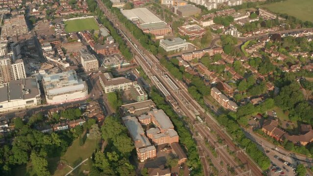 Pan down aerial shot over Elizabeth line train arriving at Maidenhead station