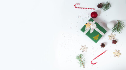 Christmas composition with gift boxes, candy cane, gingerbread, snowflakes on a white background.