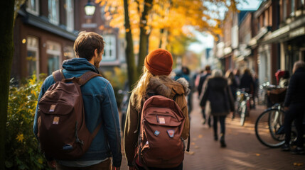 Tourists couple walking in the streets of Amsterdam. - obrazy, fototapety, plakaty