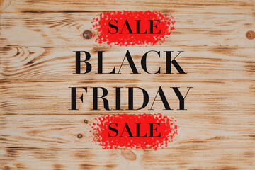 Black friday sign on wooden textured background. Brown textured wooden background, burnt wood. Background of yellow wooden boards for design
