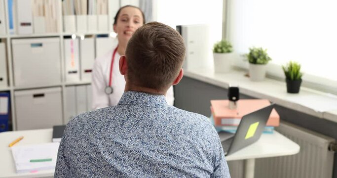 Doctor is talking to patient at clinic. Discussion of a medical diagnosis