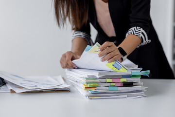 Businesswoman hands working in Stacks of paper files for searching and checking unfinished document achieves on folders papers at busy work desk office
 - obrazy, fototapety, plakaty