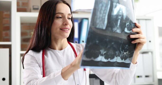 Female doctor examines an x-ray.