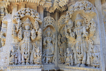Close up of detailed stone sculpture of deities on the shrine wall and pillars at Chennakesava Temple, Hoysala Architecture , Somanathpur, Karnataka, India