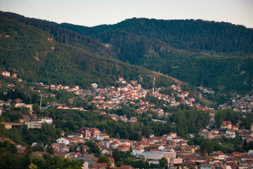 Fototapeta na wymiar Sunny Splendor: Bosnia's Uphill Houses