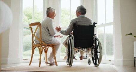 Wheelchair, senior couple and conversation in a retirement and nursing home with support and...