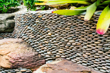 A garden of beautifully stacked rocks serves as the background.