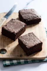 Chocolate brownie portions on marble background
