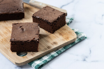 Chocolate brownie portions on marble background