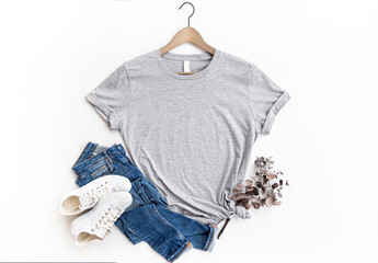 Gray womans cotton Tshirt mockup with eucalyptus , jeans, sneakers on white background. Design t...