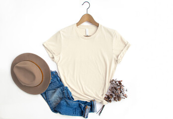 Soft Cream womans cotton Tshirt mockup with eucalyptus , jeans, hat on white background. Design t...