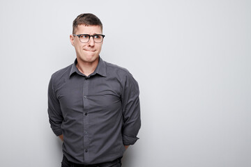 Portrait of clever man in shirt thinks doubts chooses isolated on white studio background with copy space