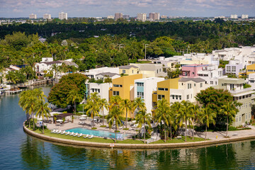 Aerial photo colorful luxury homes in Miami Beach Florida waterfront with pool