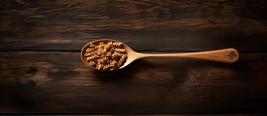 Wholemeal fusilli placed on a wooden table With copyspace for text