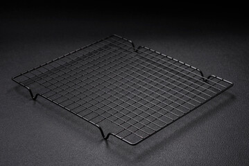 Empty black metal kitchen grate for pouring desserts