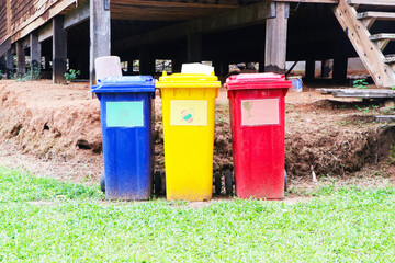 Plastic trash garbage bin can, dustbin blue, yellow, red square shape. Waste collection equipment in the park. Global warming. Beautiful modern design. Made of good quality plastic, not rusty.