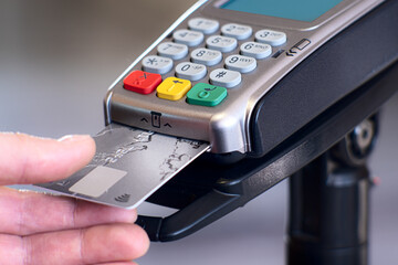 Contactless payment concept, female customer holding credit card near nfc technology on counter,...