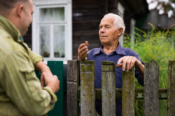 Senior man having conversation with his neighbour
