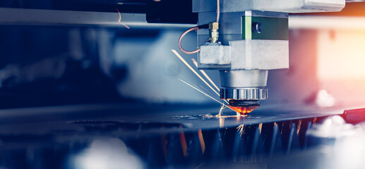 Laser CNC cut of metal with light spark, technology modern, industrial Blue color banner