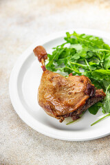 duck leg confit with berry sauce poultry meat second course vegetable delicious healthy eating cooking appetizer meal food snack on the table copy space
