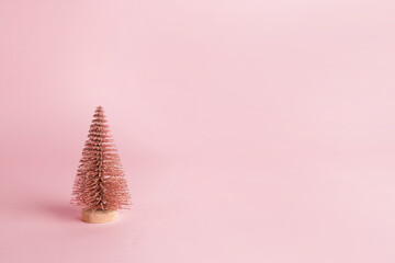 Christmas design pink pastel color background, Christmas tree with shadow. New Year greeting card in a minimalist style