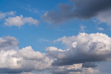 Fototapeta na wymiar A large cumulus cloud can be seen in the blue sky. Close-up
