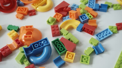 Plastic building blocks on a white background, close-up.