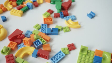 Fototapeta na wymiar Plastic building blocks on a white background, close-up.