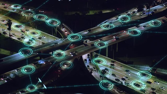 Aerial view of Big Highway Elevated Interchange. Autonomous Self Driving Cars Moving Through it. Driverless Cars with Holographic HUD Elements. Intelligent Traffic Detection System. Smart Transport