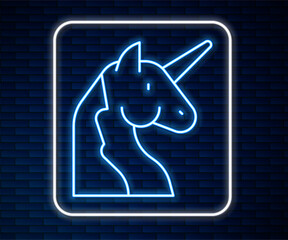 Glowing neon line Unicorn icon isolated on brick wall background. Vector