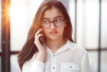 Informal Call. Young woman in glasses calling her friend, talking and asking about something