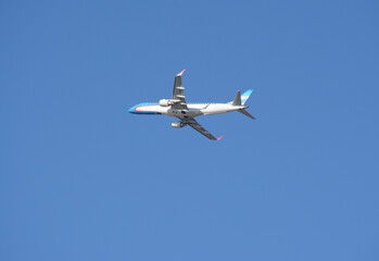 airliner flying in the blue sky, light blue and white commercial plane