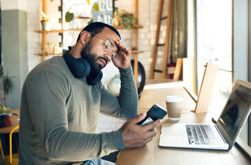 Man, phone and stress in coffee shop for remote work, job search or bad news of financial fail, debt or loan. African freelancer with headache, worry or reading on mobile, business decision and cafe - obrazy, fototapety, plakaty