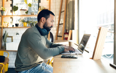 Man, remote work and laptop in cafe, productivity with freelance worker and copywriter, writing...