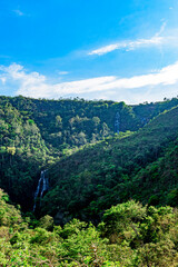 Mountains covered by forest and waterfalls on a sunny morning in the state of Minas Gerais in Brazil