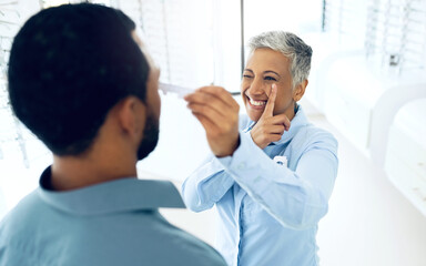 Obraz premium Woman, optometrist and patient for eye test, measurement and optical health and wellness. Happy mature doctor, smile and care for vision at clinic, ruler and fitting or exam for lenses and frame