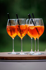 The row of glasses with Aperol Spritz summer cocktail