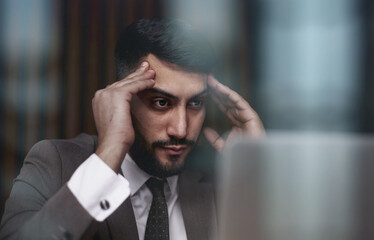 businessman working on laptop in modern office lobby space.