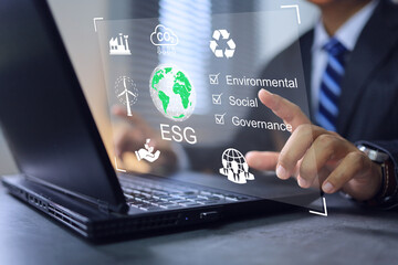 ESG environmental social governance concept. Businessman working on laptop concern co2 reduction emissions atmosphere, leading company take care environment conservation reducing carbon footprint. - obrazy, fototapety, plakaty