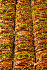 Turkish desert baklava with peanut, pistachio for holiday or ramadan. Traditional Middle Eastern Flavors. Selective focus, pattern.