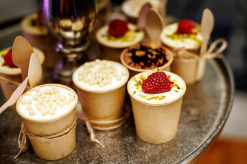 Mug cakes with raspberry in paper cups.