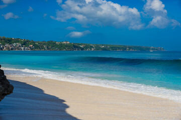 Tropical beach with blue ocean and waves in Bali