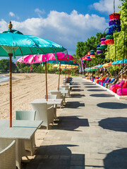 Balinese umbrellas at tropical beach in Bali. Beach club or restaurant
