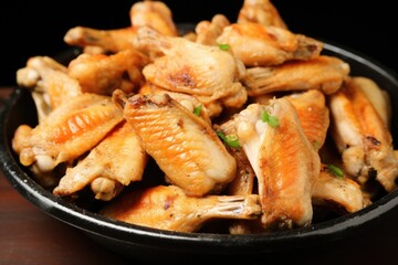 close-up shot of chicken wings tossed in white garlic sauce